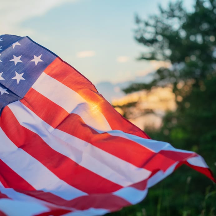 American Flag with a sunset in the background